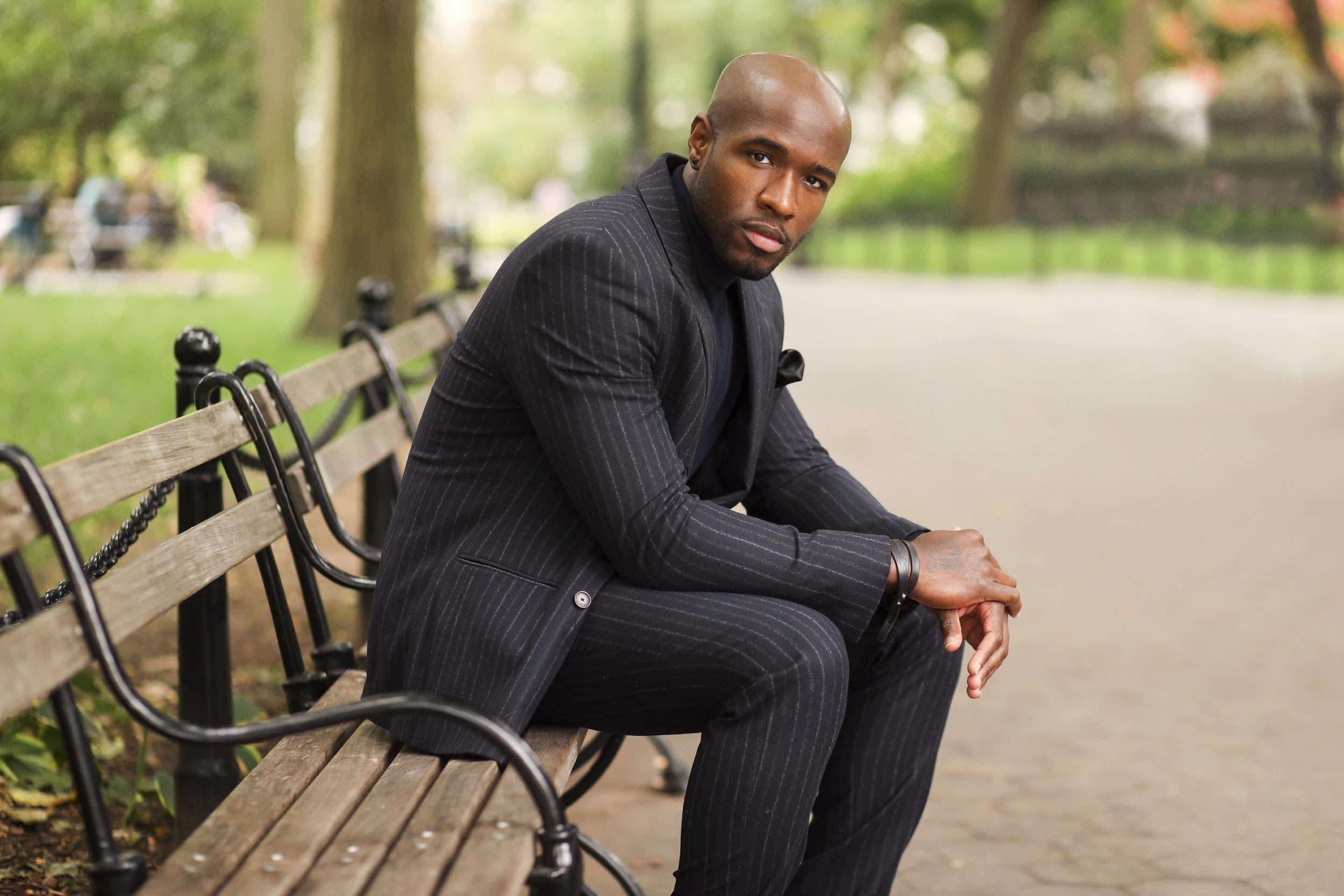 Jared Goodloe sitting in the wooden outdoor bench