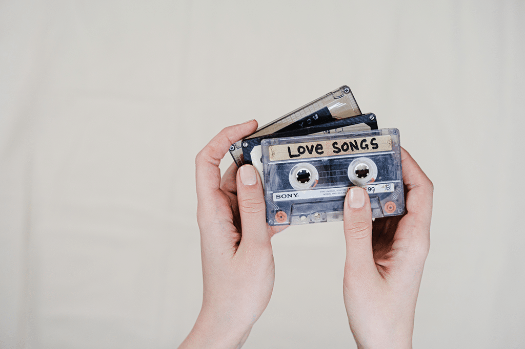 Hands holding the cassette tapes